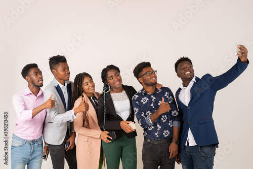 beautiful young african people on a white background are photographed on the phone