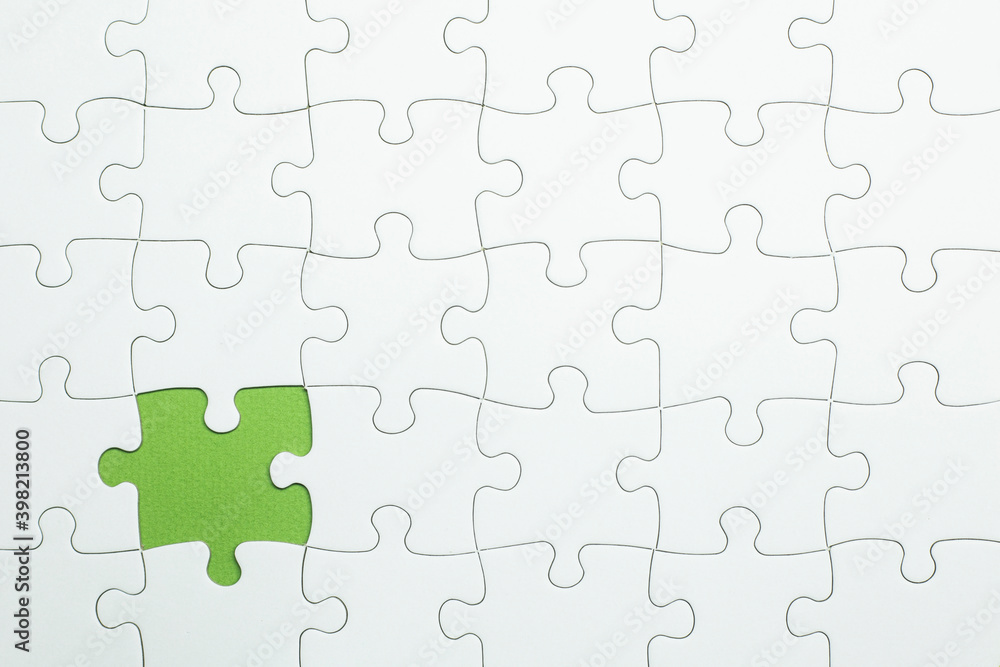 puzzle is missing piece to complete. white pieces and green space to add text puzzle is missing piece to complete. white pieces and green space to add text