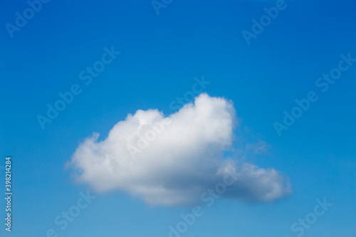 white cloud with a blue sky in the background.