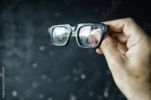 glasses vision concept, man holds glasses in his hand.