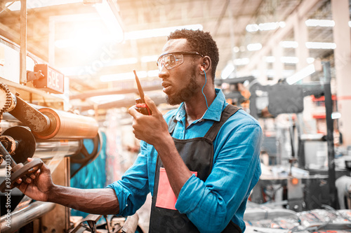 Technician working in factory check functionality while commissioning a production line, Man working