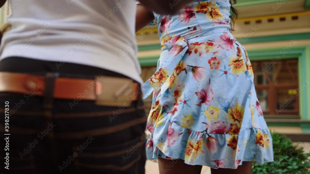 Joyful afro dancers holding hands on street. African couple performing in city Joyful afro dancers holding hands on street. African couple performing in city