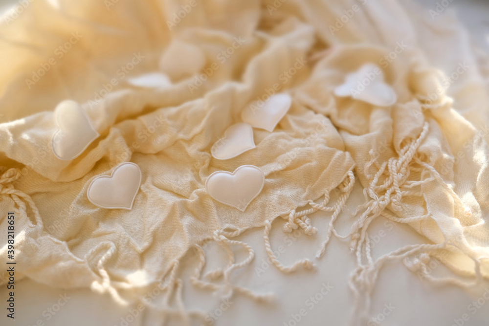 Valentines day or wedding still life scene, White hearts on light beige delicate soft background of fabric folds , shadow and sunlight, romantic concept. copy space Valentines day or wedding still life scene, White hearts on light beige delicate soft background of fabric folds , shadow and sunlight, romantic concept. copy space