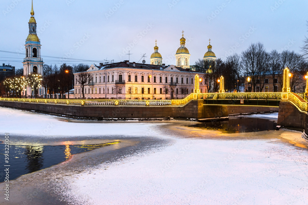 St. Petersburg in the Christmas holidays. Locality of the Seven Bridges at the confluence of the Griboyedov and Kryukov Canals near the St. Nicholas Cathedral in the evening illumination