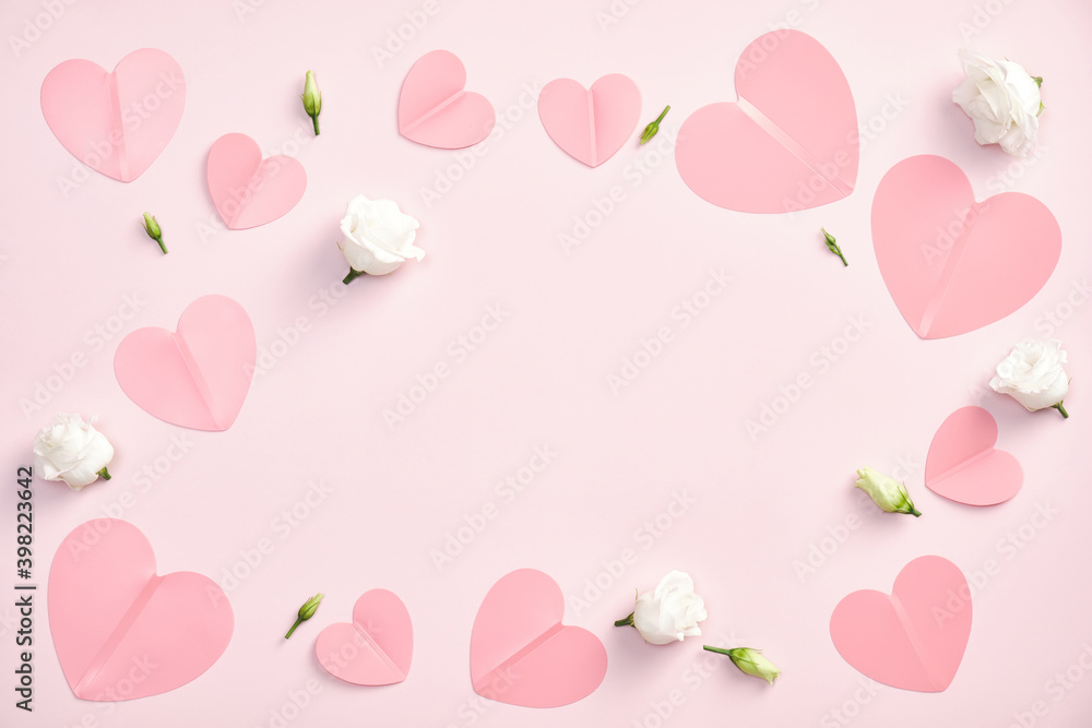 Valentines day flat lay composition. Top view pink paper hearts and white buds of rose flowers on pastel pink background. Minimal style. Love, romance concept.