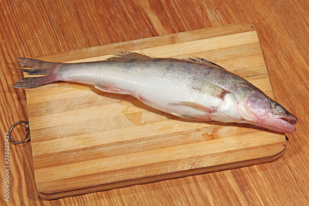 Pike perch fish of Azov sea on wooden cutting board. Pike perch fish of Azov sea on wooden cutting board.