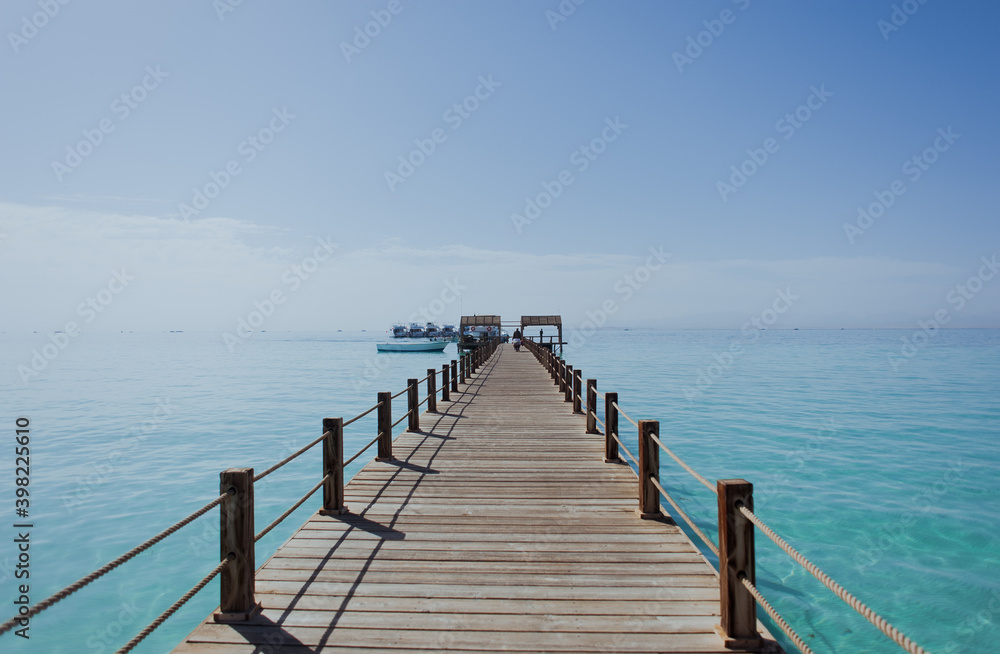 man walks across the bridge. Around blue Water. Sea. Ocean. Summer, Heat. Egypt. Orange bay