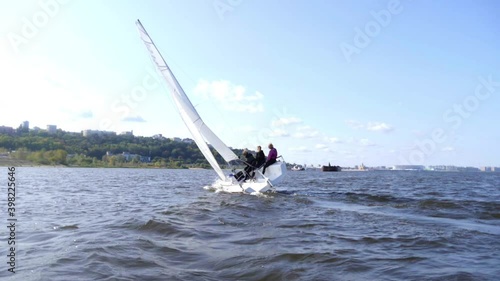 Dangerous maneuver on a sailing yacht, the boat tilted during the turn with slowmotion effect.