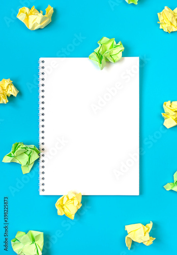 Fototapeta Naklejka Na Ścianę i Meble -  Bright creativity concept of the idea, white notepad and colorful crumpled papers, flat lay