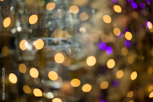Golden abstract blurred defocused bokeh background.Background with reflections of cars in glass