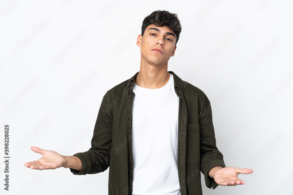 Young man over isolated white background having doubts Young man over isolated white background having doubts
