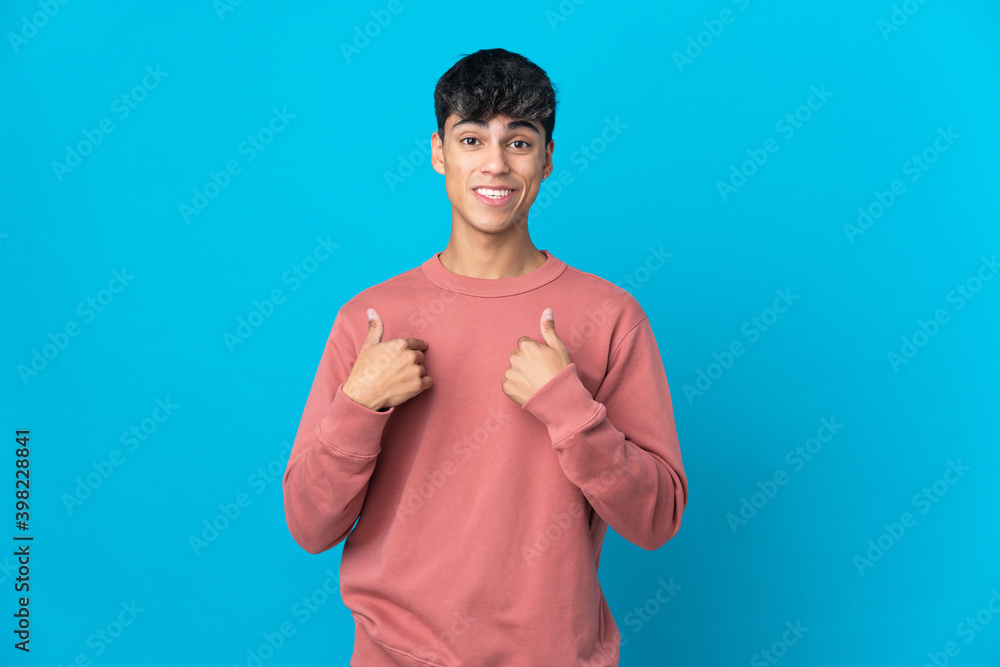 Young man over isolated blue background with surprise facial expression Young man over isolated blue background with surprise facial expression