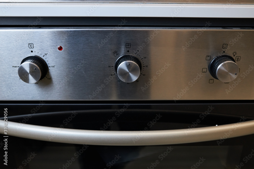 White / black / electric stove close-up switch. Close-up of the knob of the switch of a gas stove. Close-up white / black electric stove control knobs. Soft focus. White / black / electric stove close-up switch. Close-up of the knob of the switch of a gas stove. Close-up white / black electric stove control knobs. Soft focus.
