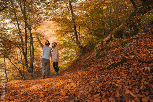 Young couple admiring the forest covered by leafs in autumn. © Davi Zapico