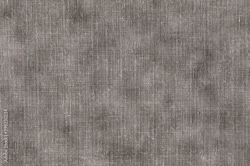 Texture of coarse burlap, natural linen material of dark color with spots. Rough dirty brown cloth with spots.