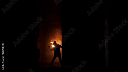 Terrorist trows molotov's cocktail in the wall, wide lens footage. Bright fire in abandoned shelter looking like post apocalypse.