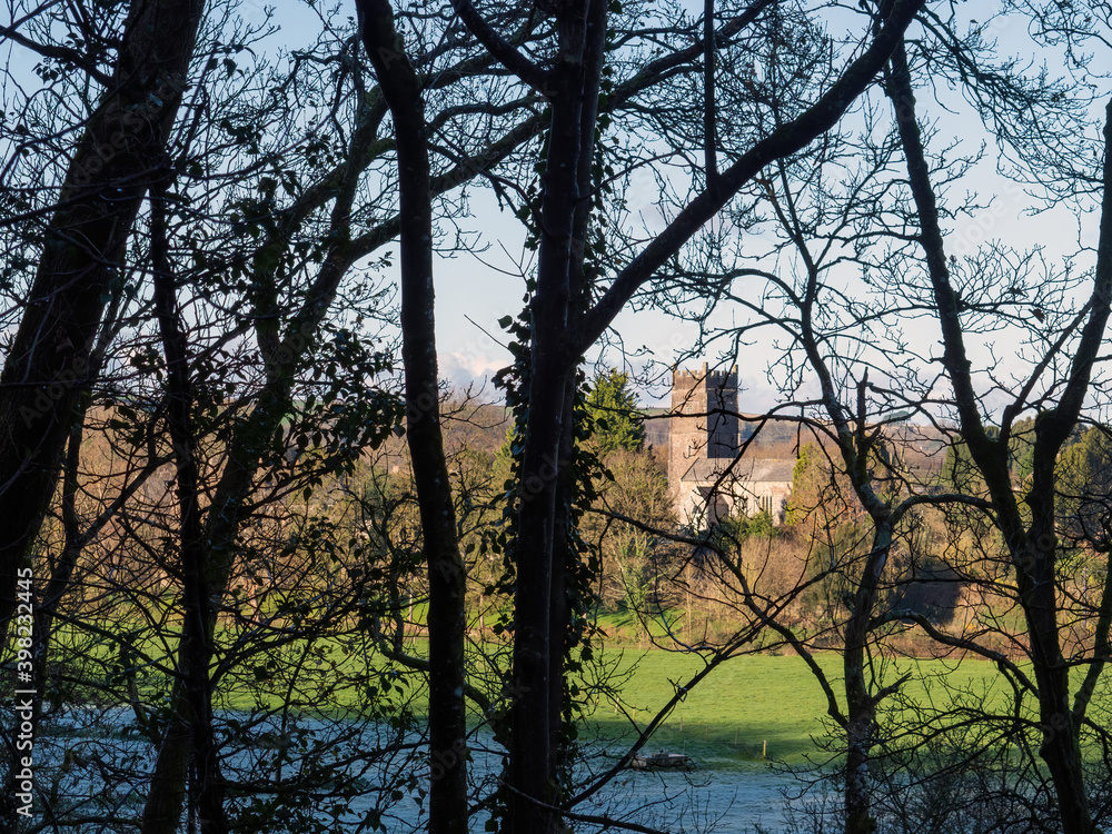Weare Gifford church glimpsed through the trees on the Tarka Trail between Bideford and Torrington. Winter. Weare Gifford church glimpsed through the trees on the Tarka Trail between Bideford and Torrington. Winter.
