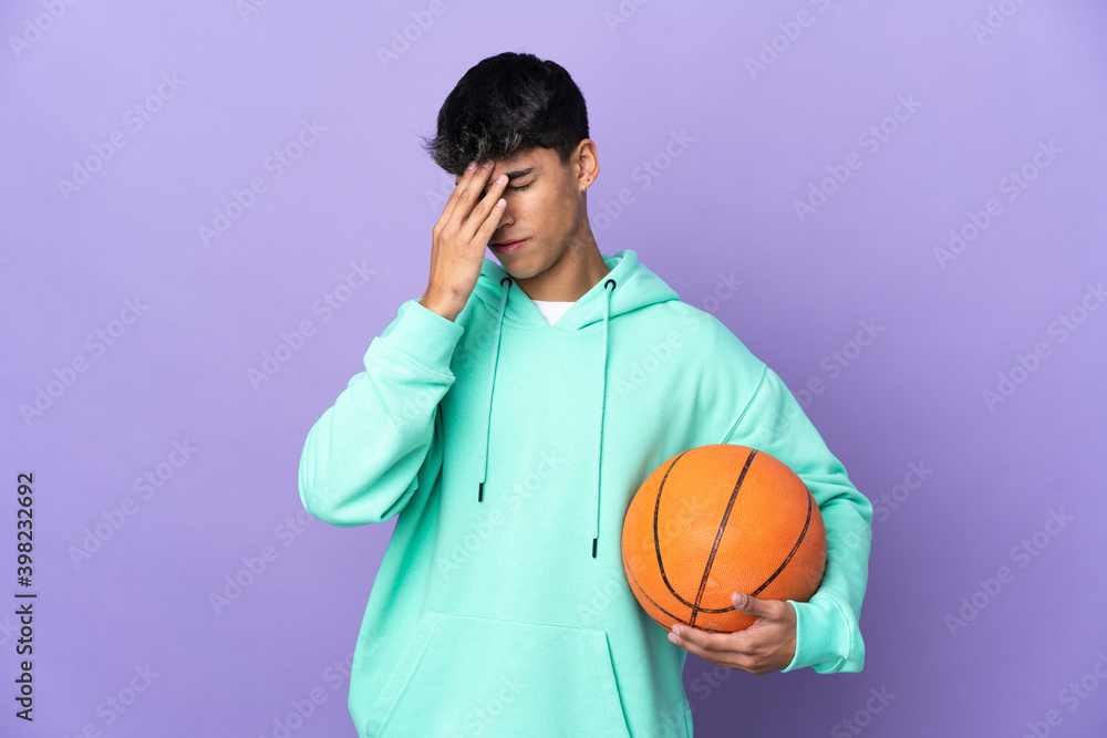 Young man playing basketball over isolated purple background with tired and sick expression