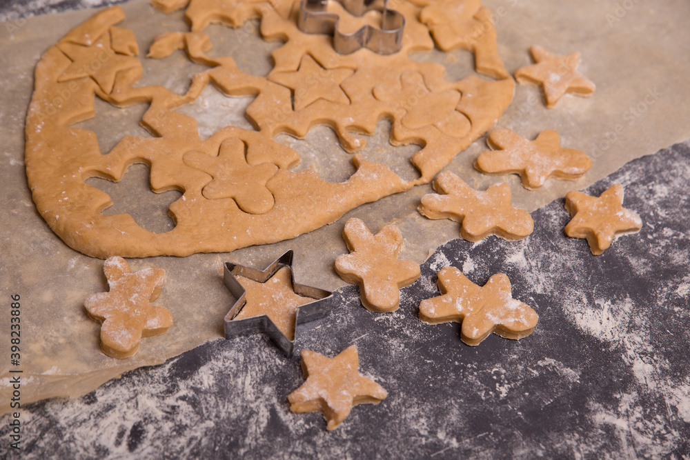 Homemade uncooked dough cookies, gingerbread making process. cut out Christmas cookies. Homemade uncooked dough cookies, gingerbread making process. cut out Christmas cookies.