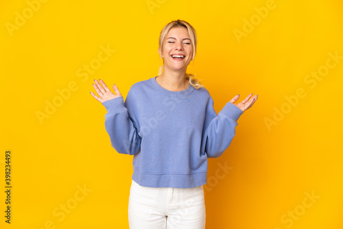 Young Russian woman isolated on yellow background smiling a lot