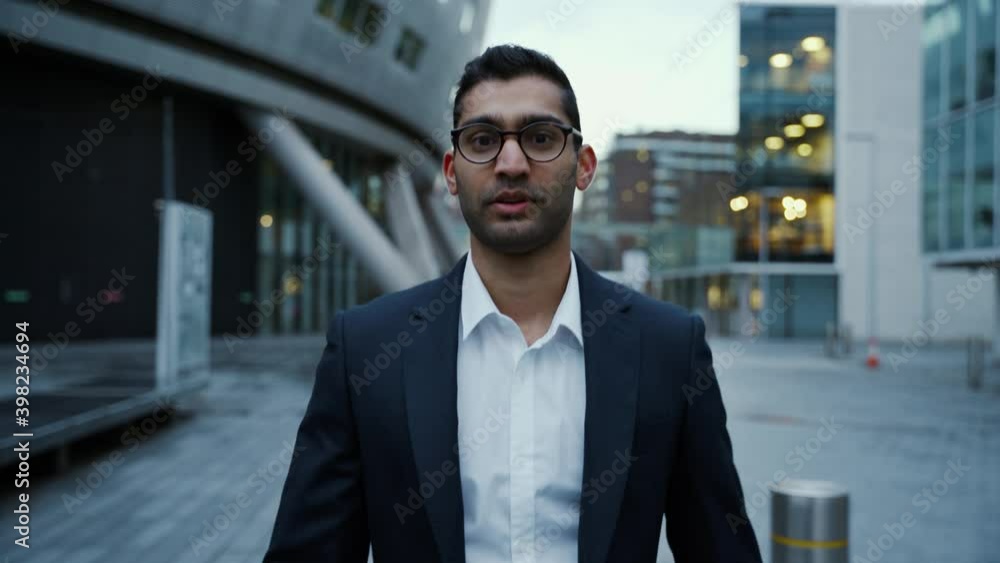 Mixed race businessman walking home after long day of work Mixed race businessman walking home after long day of work