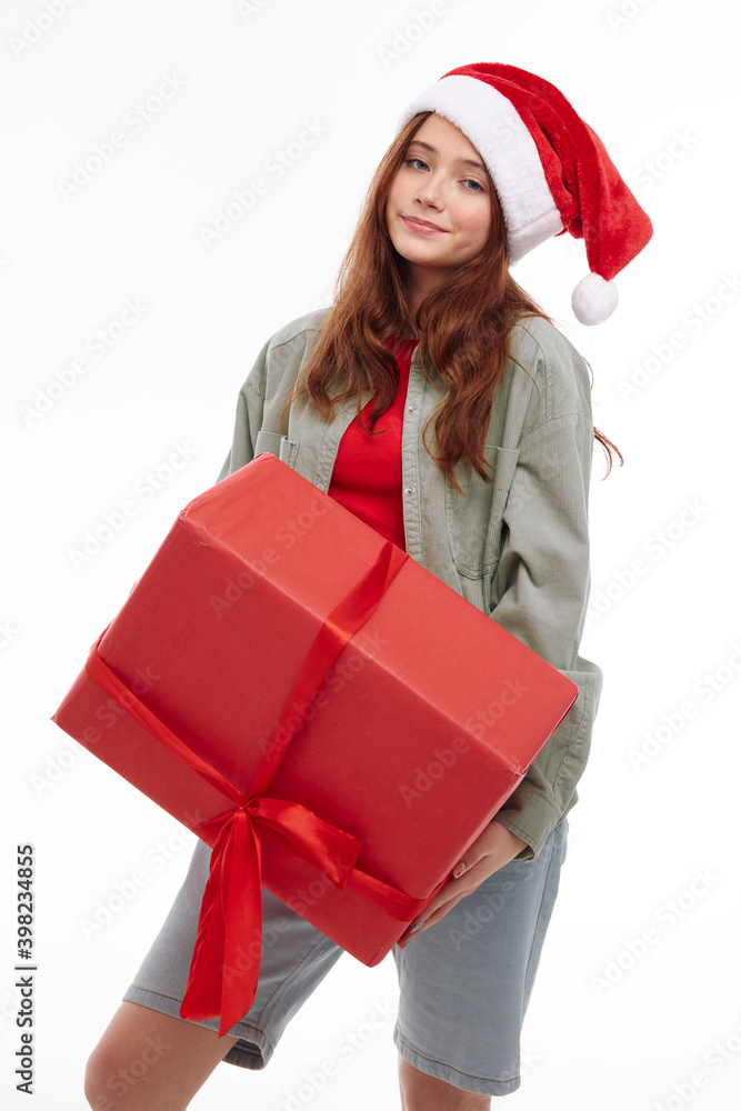 girl with a big red gift in her hands Christmas hat Christmas Studio girl with a big red gift in her hands Christmas hat Christmas Studio