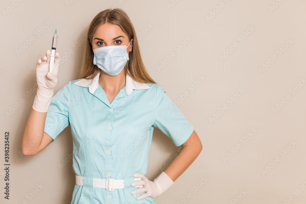 Portrait of nurse with protective mask  holding injection.