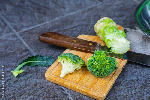 .Raw broccoli cut in a wooden chopping board