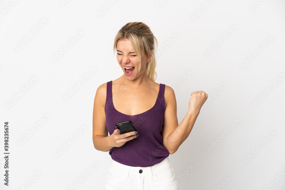 Young Russian woman isolated on white background with phone in victory position Young Russian woman isolated on white background with phone in victory position