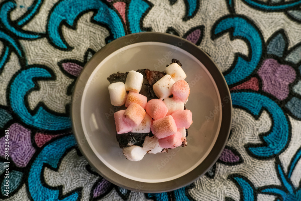 Rocky road brownies with marshmallows on colorful background