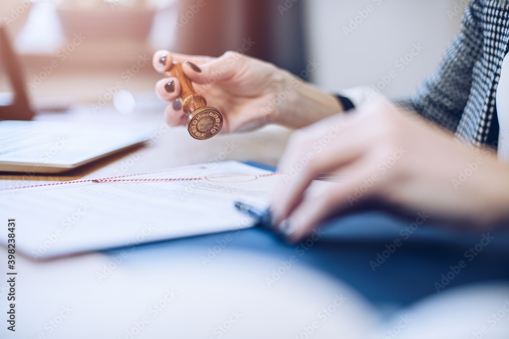 Woman notary public or judge stamping and authorizing document