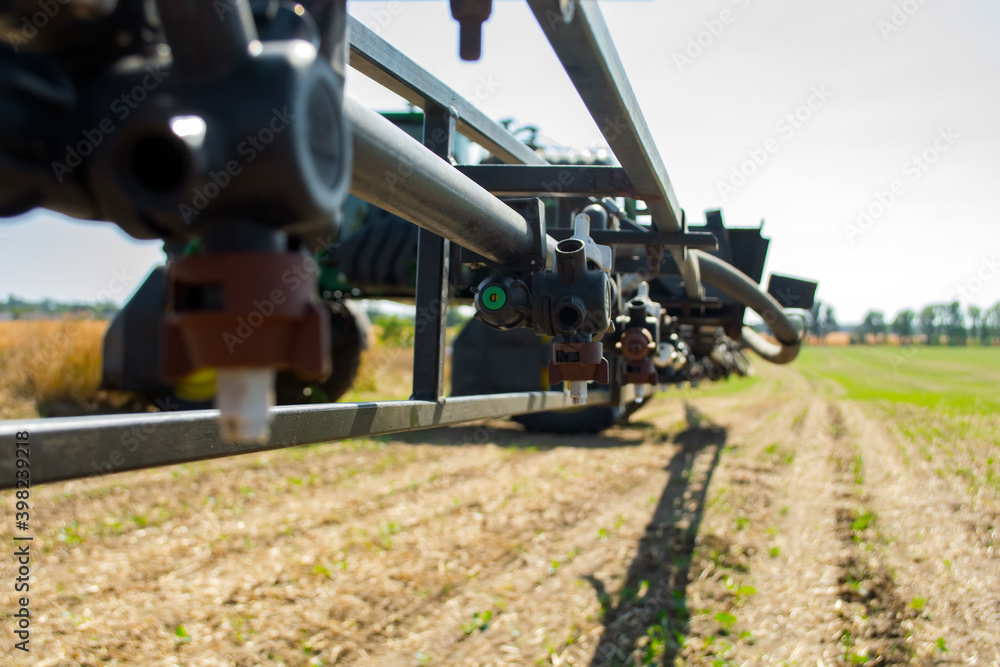 replaceable sprayer of a field high-clearance sprayer on a hinged boom replaceable sprayer of a field high-clearance sprayer on a hinged boom