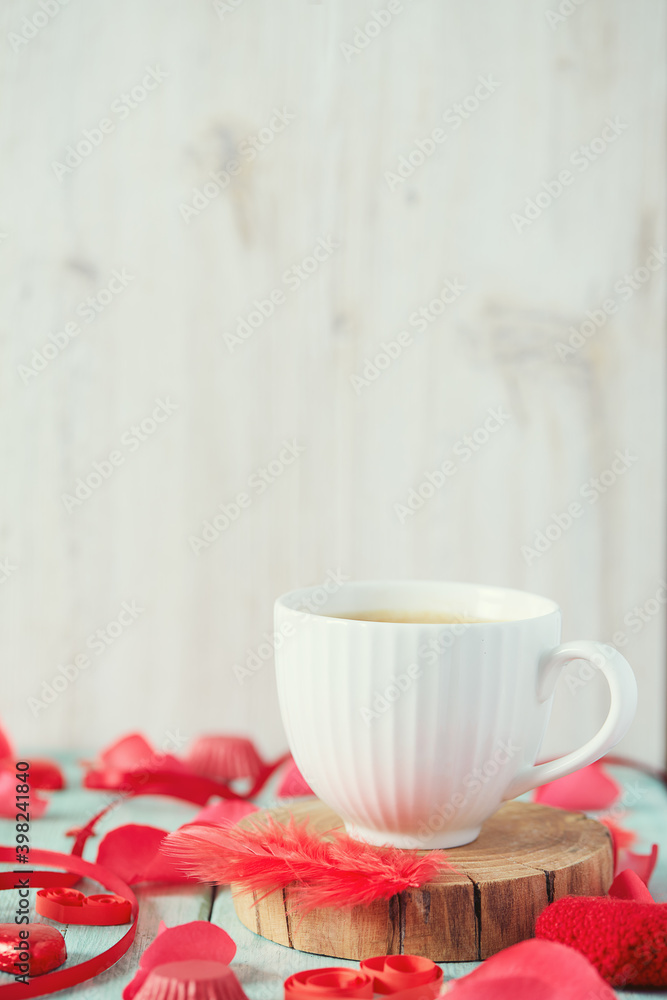 Fototapeta premium cup of coffee and hearts on light surface