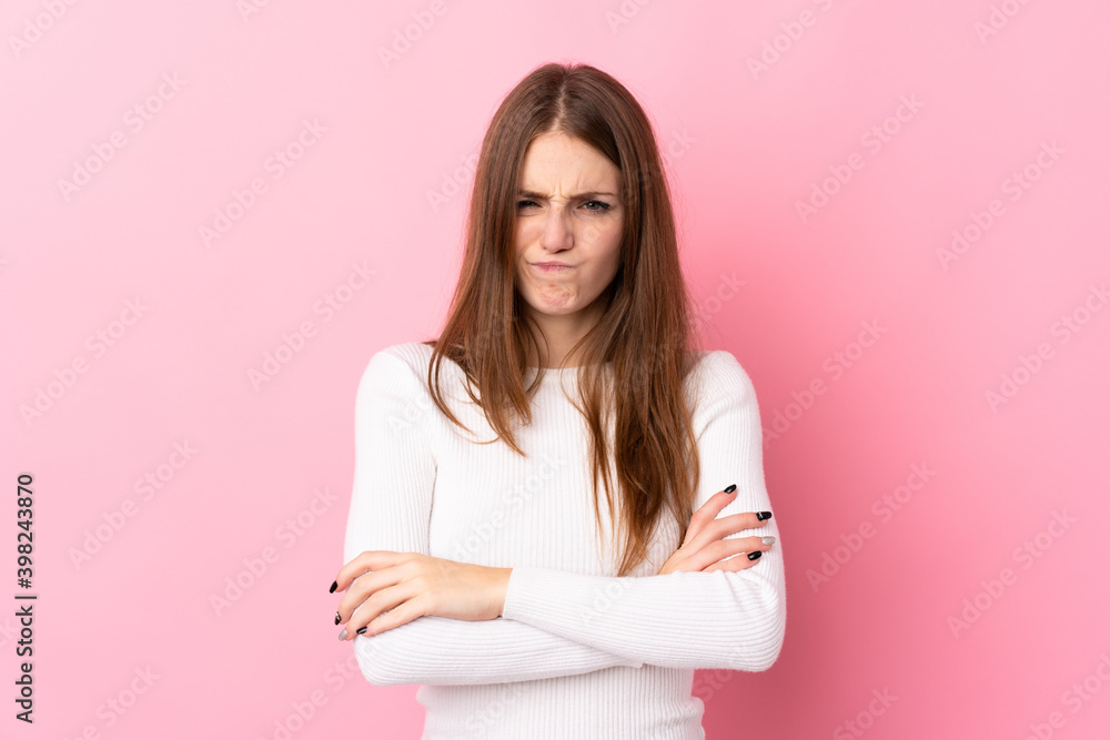 Young woman over isolated pink background feeling upset Young woman over isolated pink background feeling upset