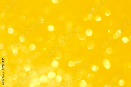 Yellow defocused bokeh glitter lights background sunny summer vibes toned