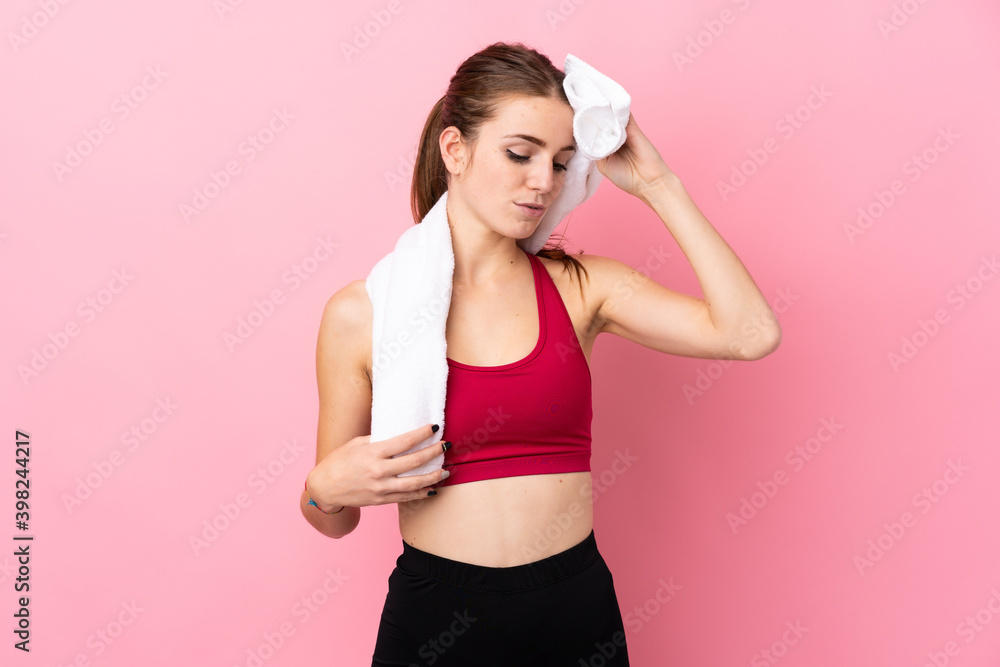 Young sport woman over isolated pink background with sport towel Young sport woman over isolated pink background with sport towel