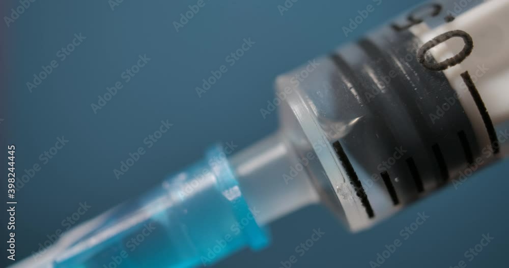 Close Up of Injection Liquid Being In Syringe Against Red Background. Medication Drug Needle Syringe Drug, Flu Shot Vaccine Vial Dose Hypodermic Injection Treatment Disease Prevention Immunization. Close Up of Injection Liquid Being In Syringe Against Red Background. Medication Drug Needle Syringe Drug, Flu Shot Vaccine Vial Dose Hypodermic Injection Treatment Disease Prevention Immunization.