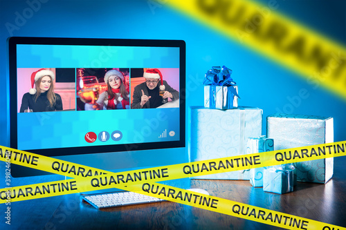 Online Christmas party during quarantine. People wish their friends a happy New year in a virtual conference. Time spent with family during the pandemic. The new format of the Christmas celebration.