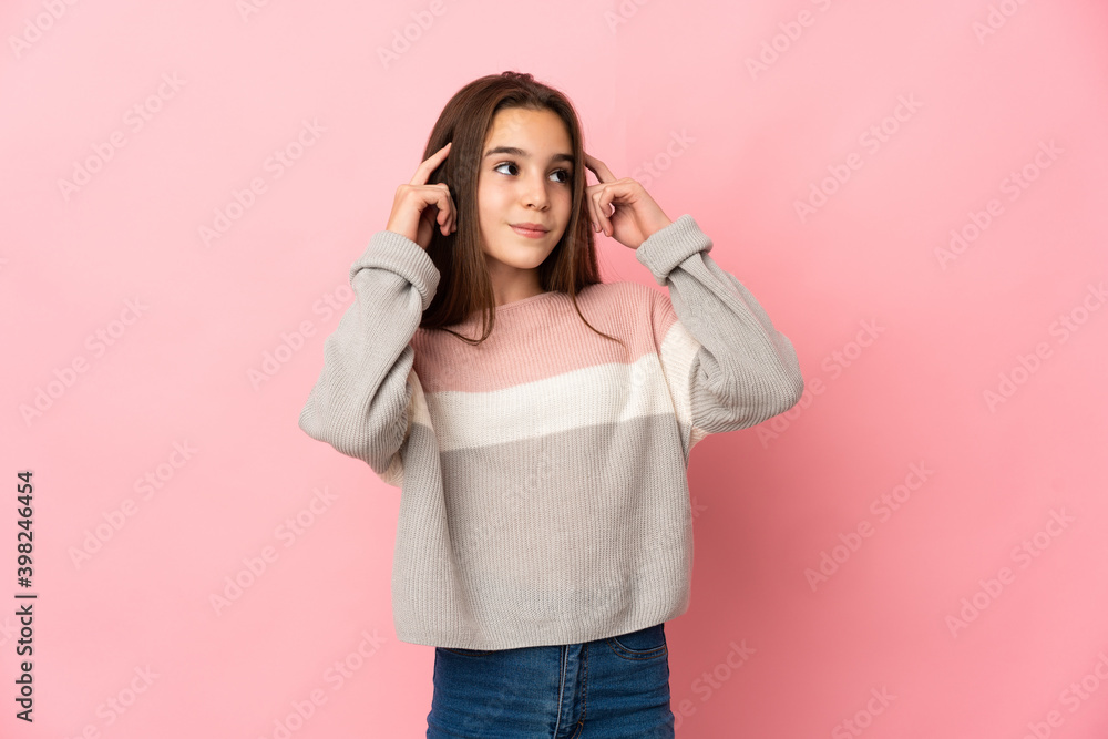 Little girl isolated on pink background having doubts and thinking Little girl isolated on pink background having doubts and thinking