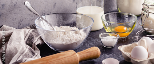 Cooking ingredients for dough, eggs, flour, sugar, milk.