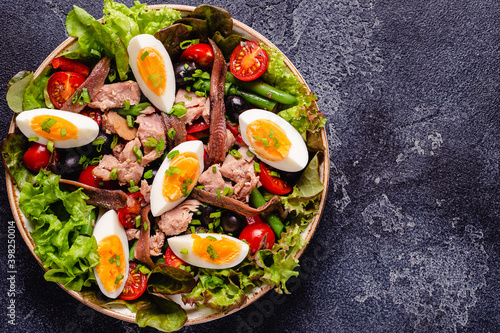 salad Nicoise with tuna, eggs, green beans, tomatoes, olives, lettuce and anchovies