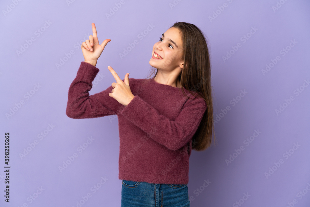 Little girl isolated on purple background pointing with the index finger a great idea Little girl isolated on purple background pointing with the index finger a great idea