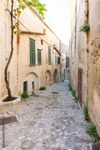 Fototapeta Naklejka Na Ścianę i Meble -  Small street with cobblestone stairs in Unesco town Matera, Italy