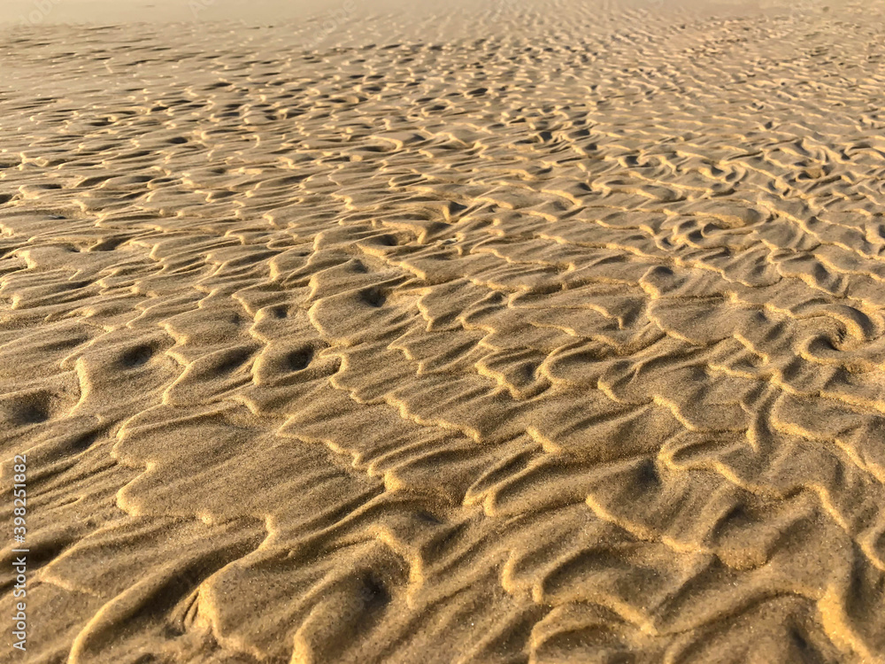 Fototapeta premium Wave patterns on the beach sand in close-up