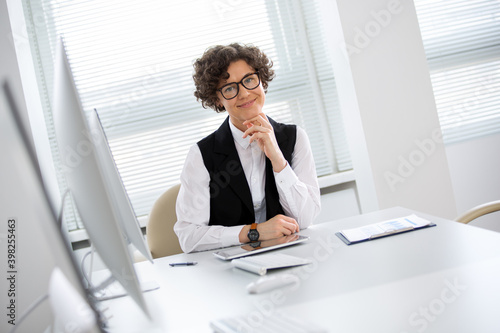 Portrait of a business woman with glasses at workplace in office