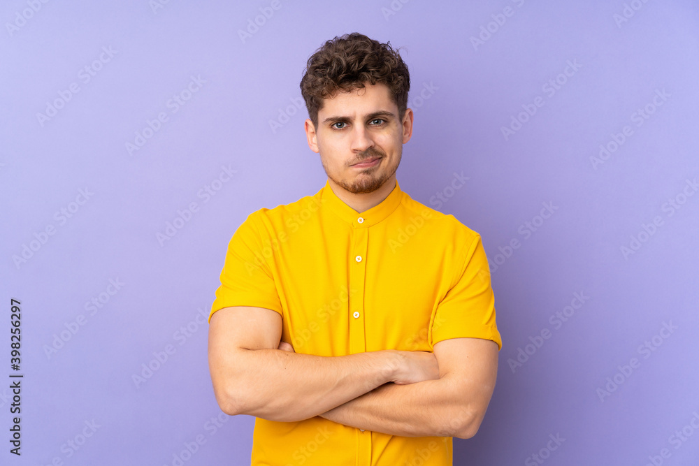 Caucasian man isolated on purple background feeling upset Caucasian man isolated on purple background feeling upset