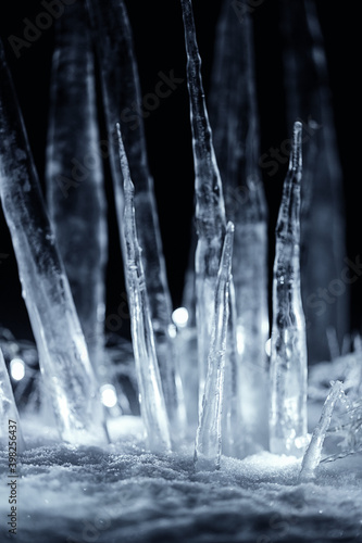 crystal icicles in snow at dark night