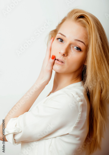young blond woman on white backgroung gesture thumbs up, isolated emotional posing close up, lifestyle people concept