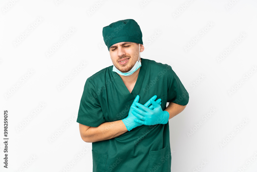 Surgeon in green uniform isolated on isolated white background having a pain in the heart