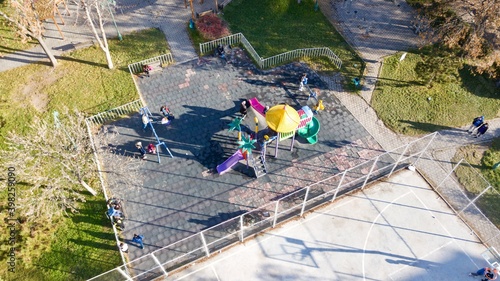 aerial view of street basketball court and children playground. kids are playing football at the sunset.